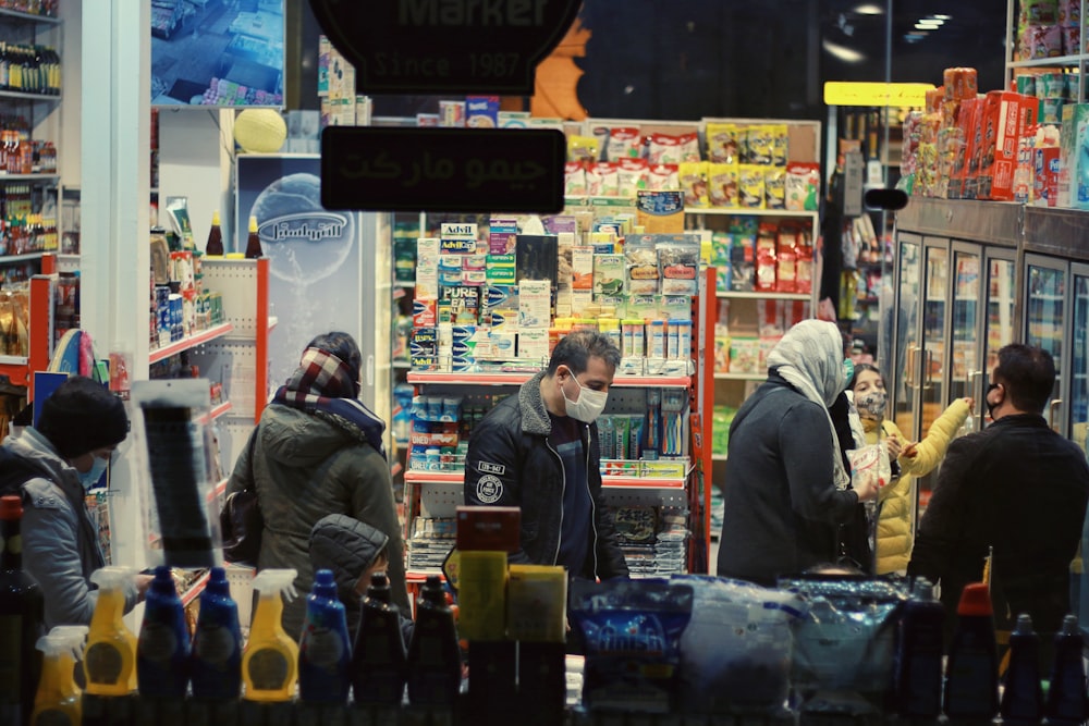 man in black jacket standing in front of store