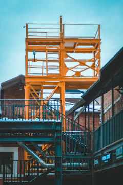 An industrial facility with bold orange structural elements and black detailing.