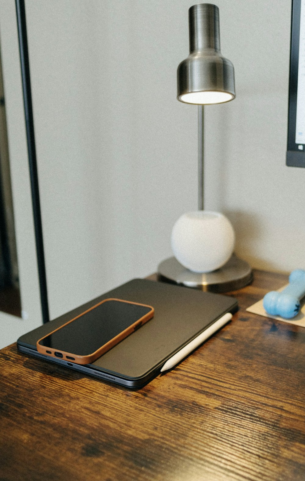 black ipad on brown wooden table