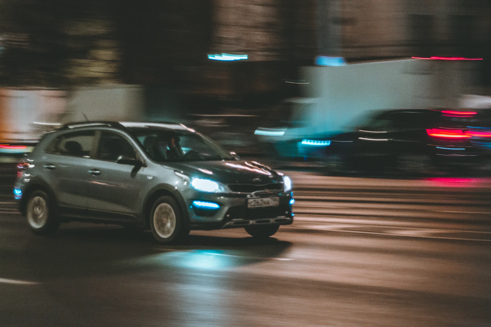 A car moving quickly through a city at night