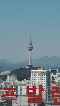white and brown concrete building near green trees during daytime