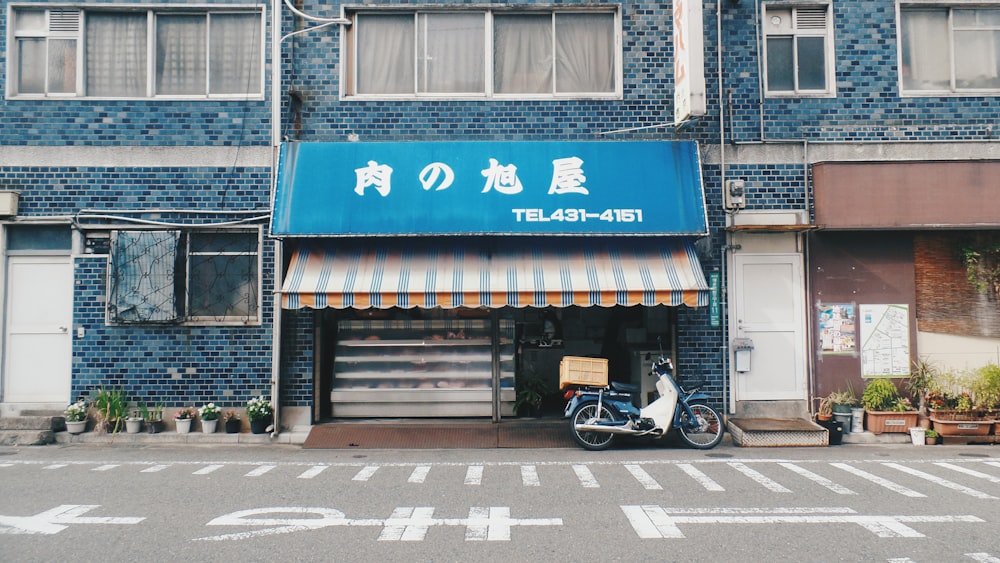 black motorcycle parked beside store