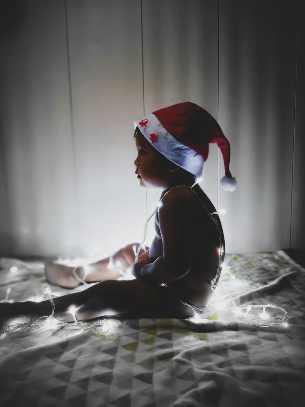 woman in red and white santa hat sitting on bed