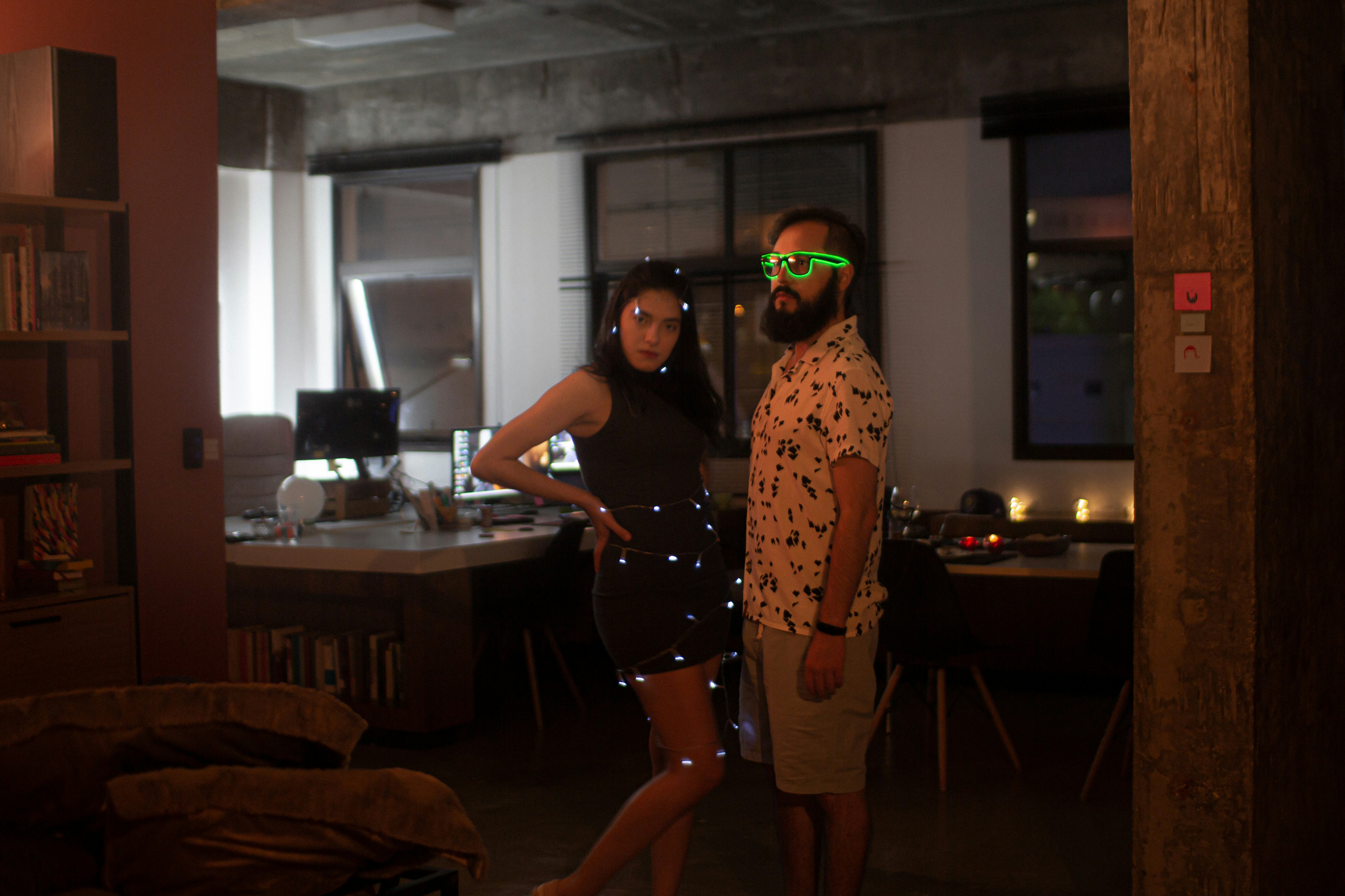 woman in black tank top and black shorts standing beside brown wooden table