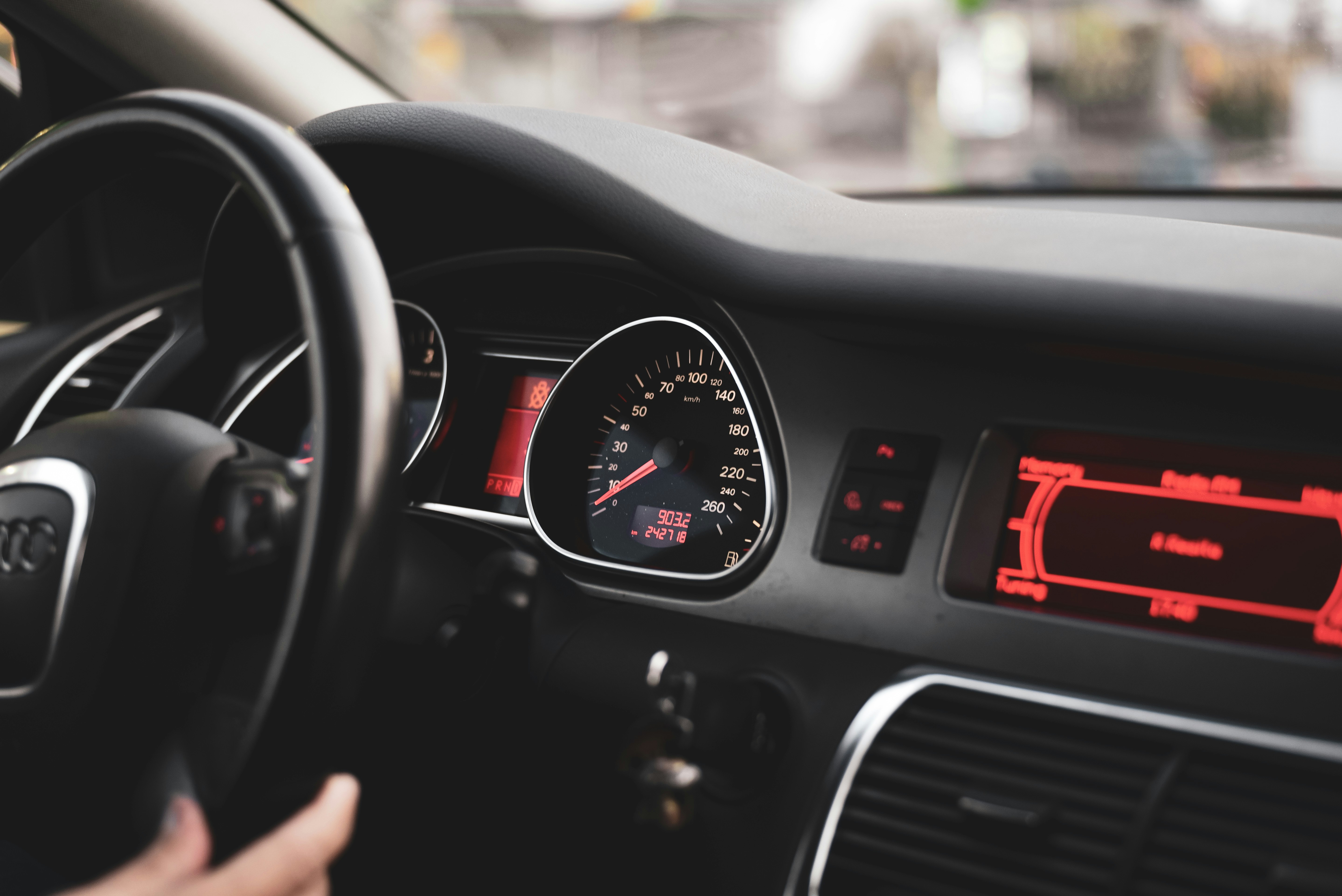 technician connecting diagnostic scanner tool to vehicle OBD II port under dashboard
