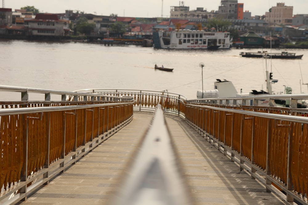 brown wooden bridge over body of water during daytime