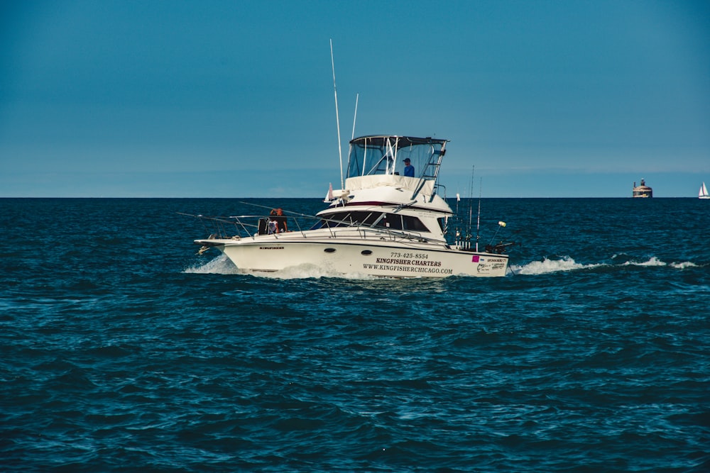 white and blue yacht on sea during daytime