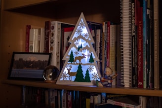An elegant shelf displaying Christian books and decorative accents.