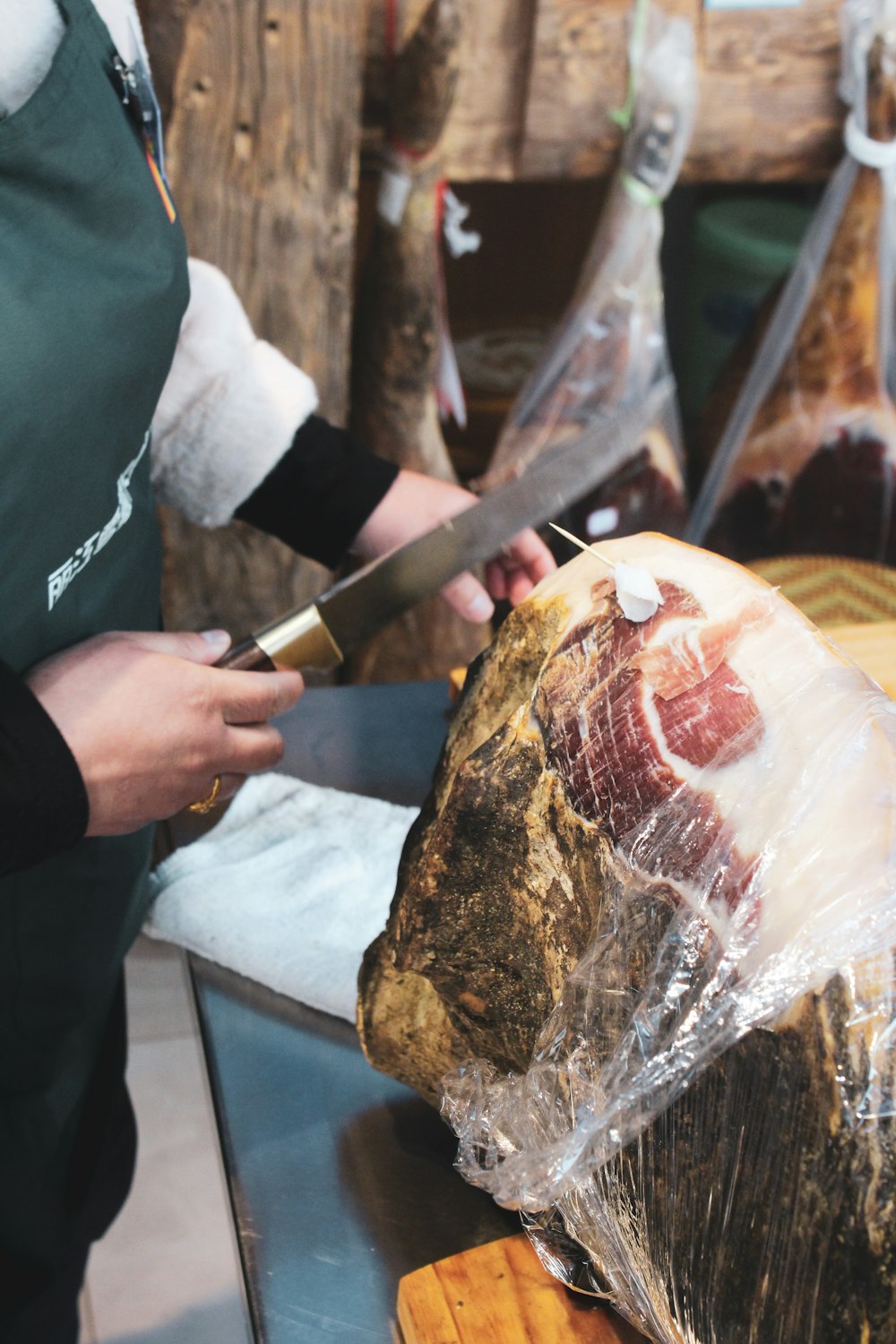 person slicing meat on table