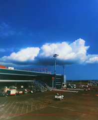 A taxi arriving on time at an airport terminal with a clear sky.