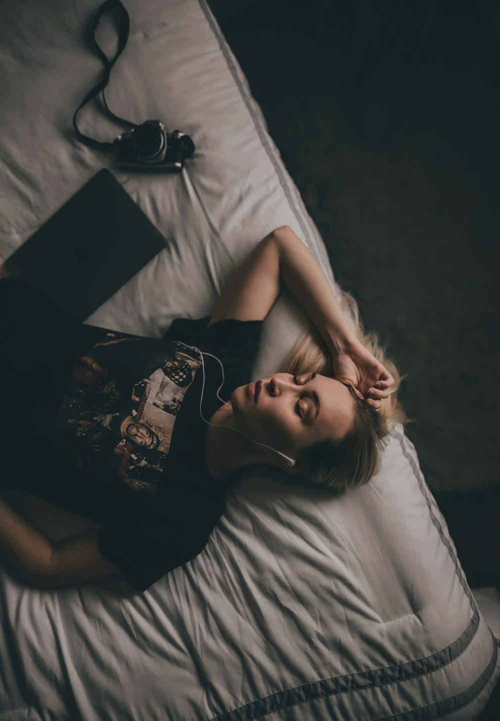 woman in black tank top lying on bed