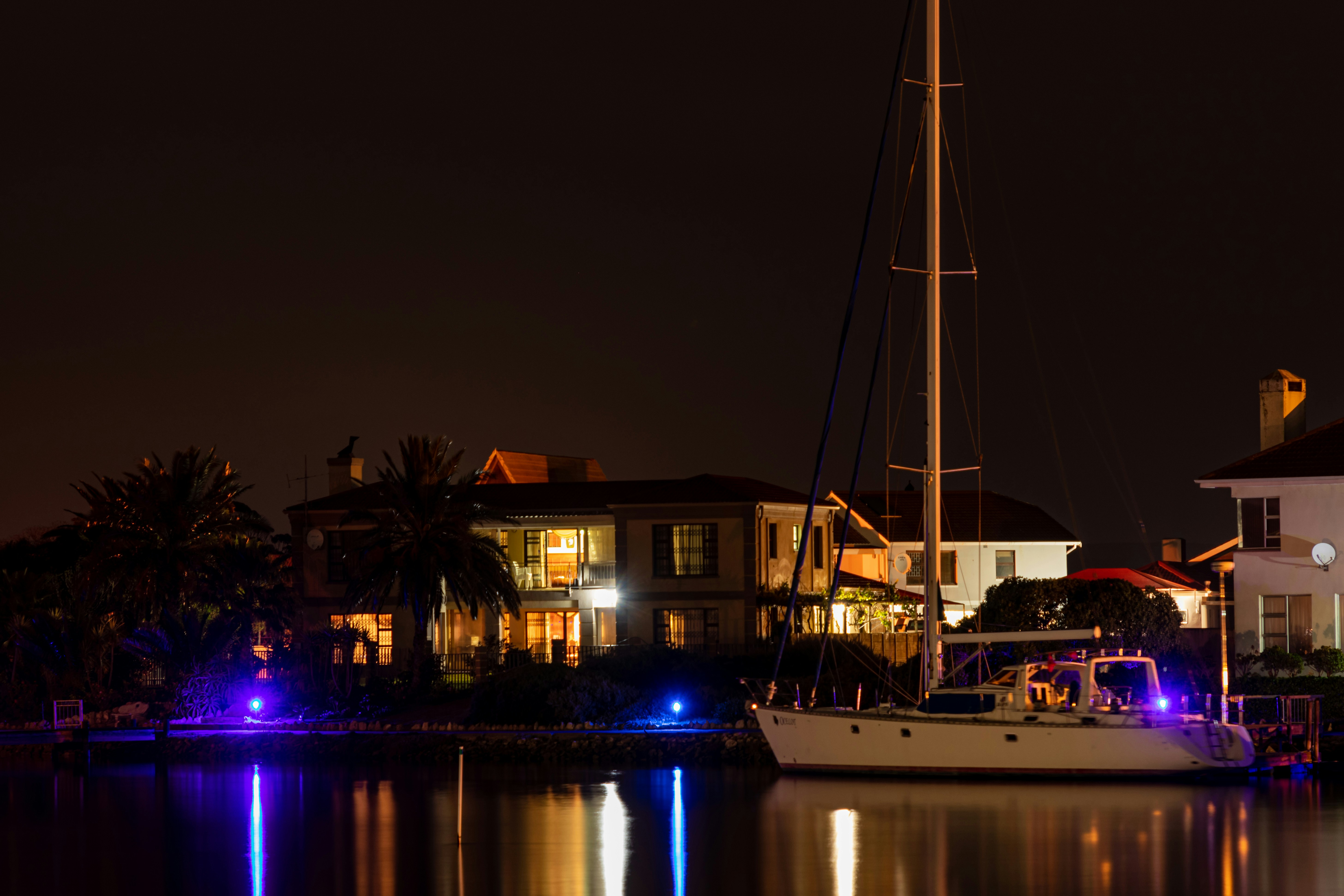 white boat on dock during night time