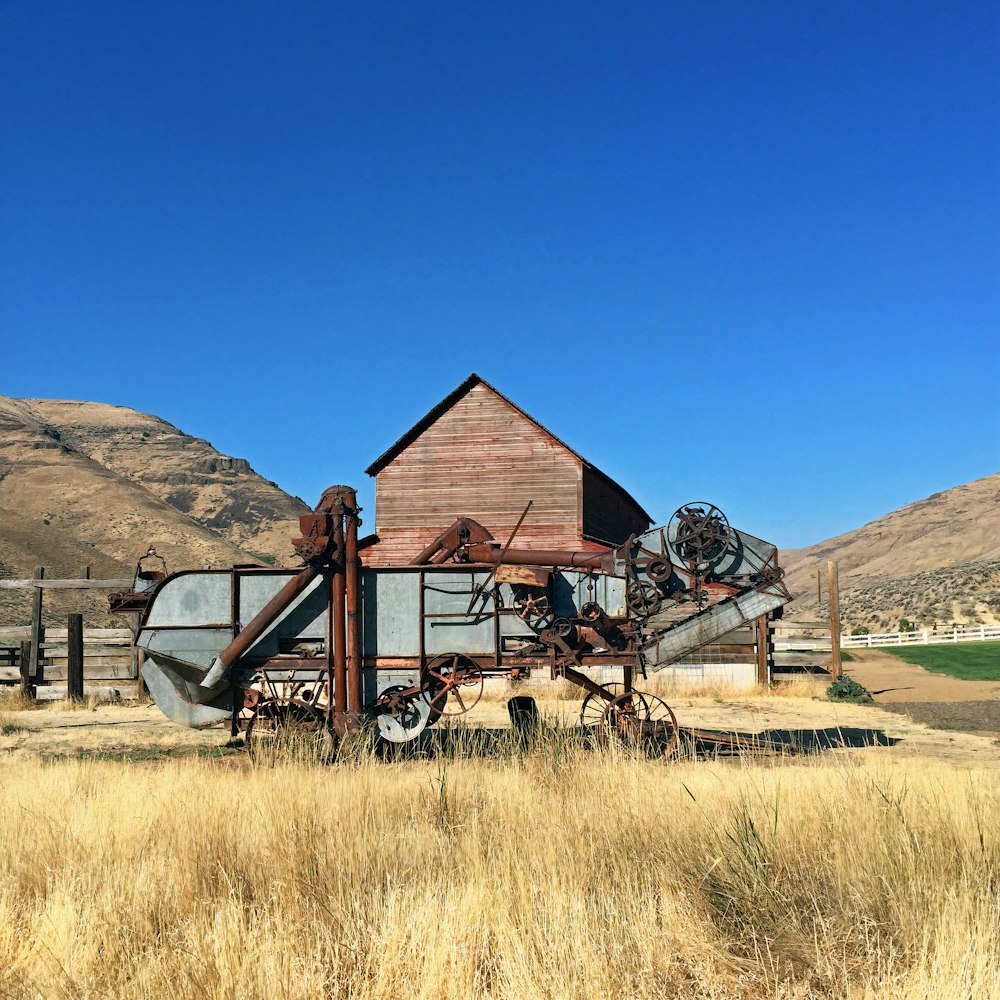 brown wooden house on green grass field during daytime