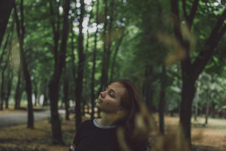 Serene image of a person breathing deeply in a green forest.