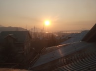 Sunset over a quiet residential plot, highlighting the peaceful environment and open space.