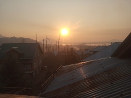 Sunset view over Holvi Residence showing warm lights from houses and calm surroundings.