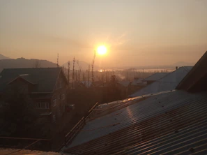 Sunset view over a quiet residential area with traditional Thai houses in Trat.