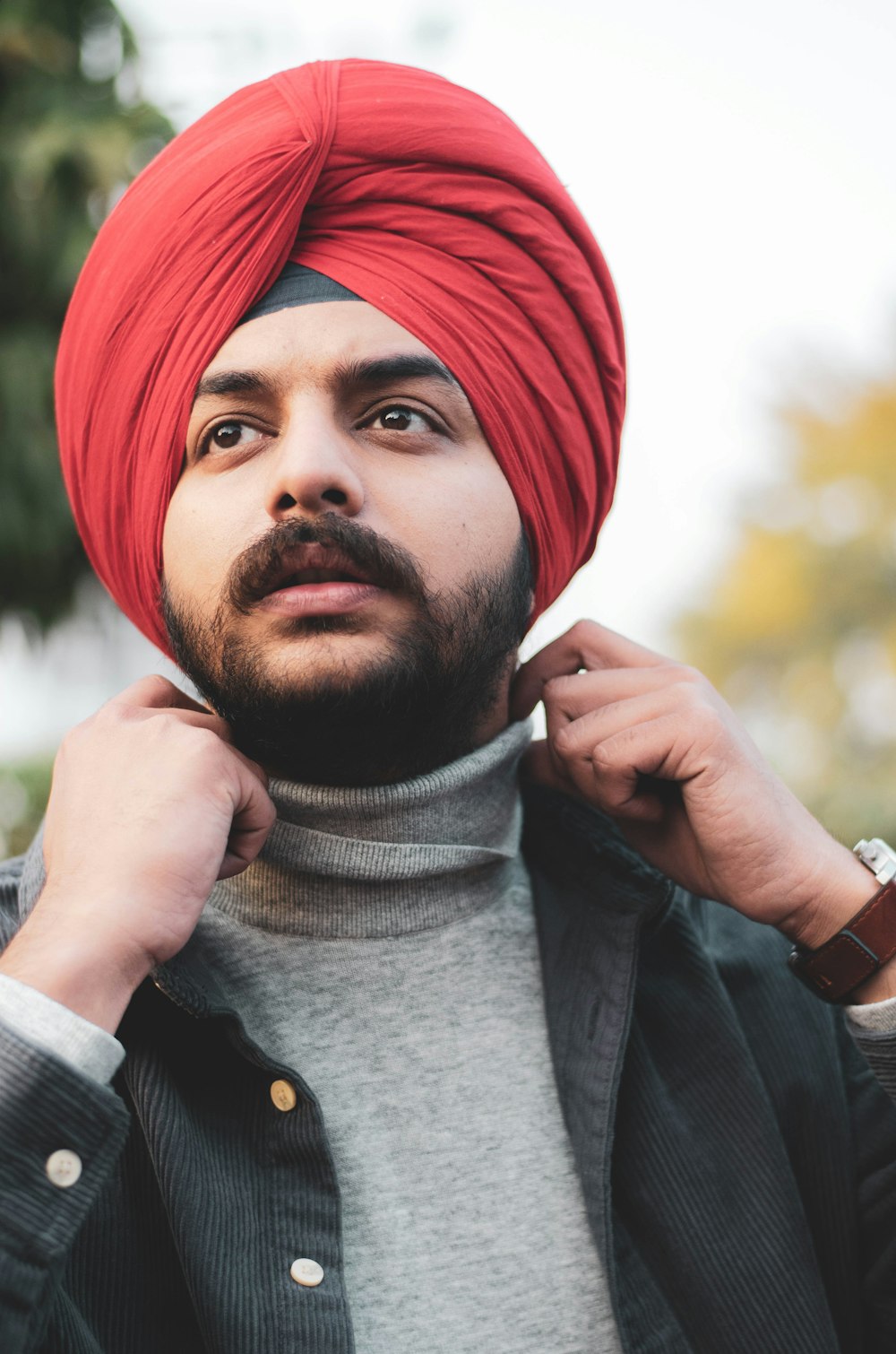 man in red knit cap and black jacket