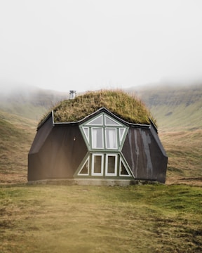 gray wooden house on green grass field