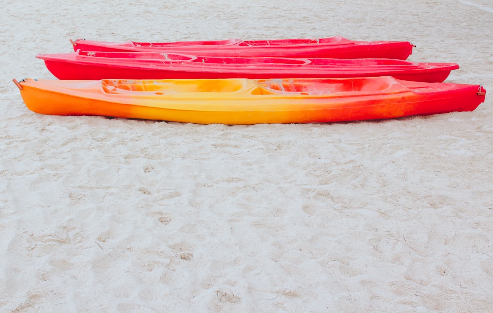 red and yellow kayak on white marble table