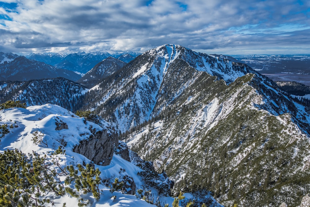 snow covered mountain under cloudy sky during daytime