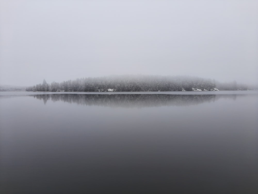 body of water under white sky