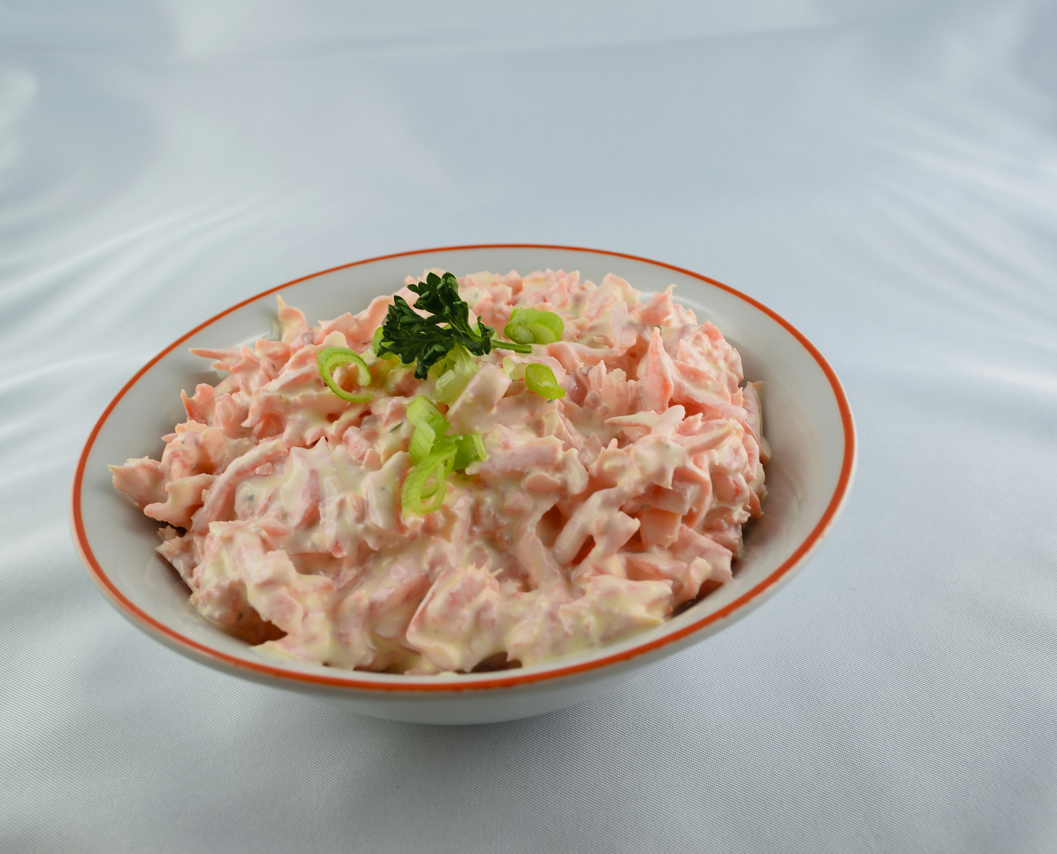 Creamy homemade coleslaw in a small bowl with fresh herbs