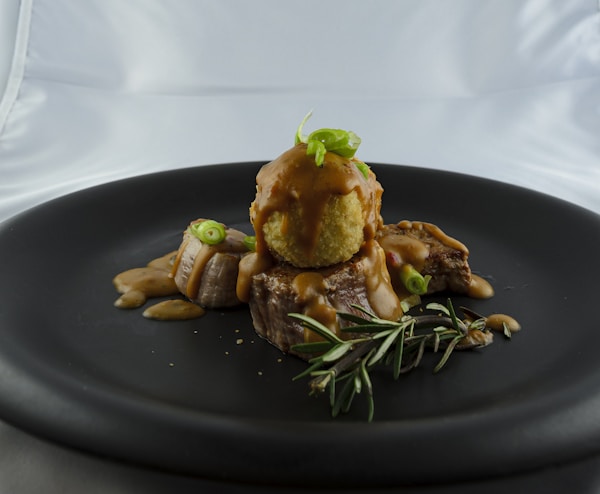Cooked food on black plate