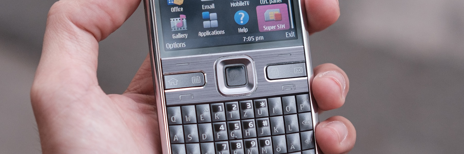 person holding gray nokia qwerty phone