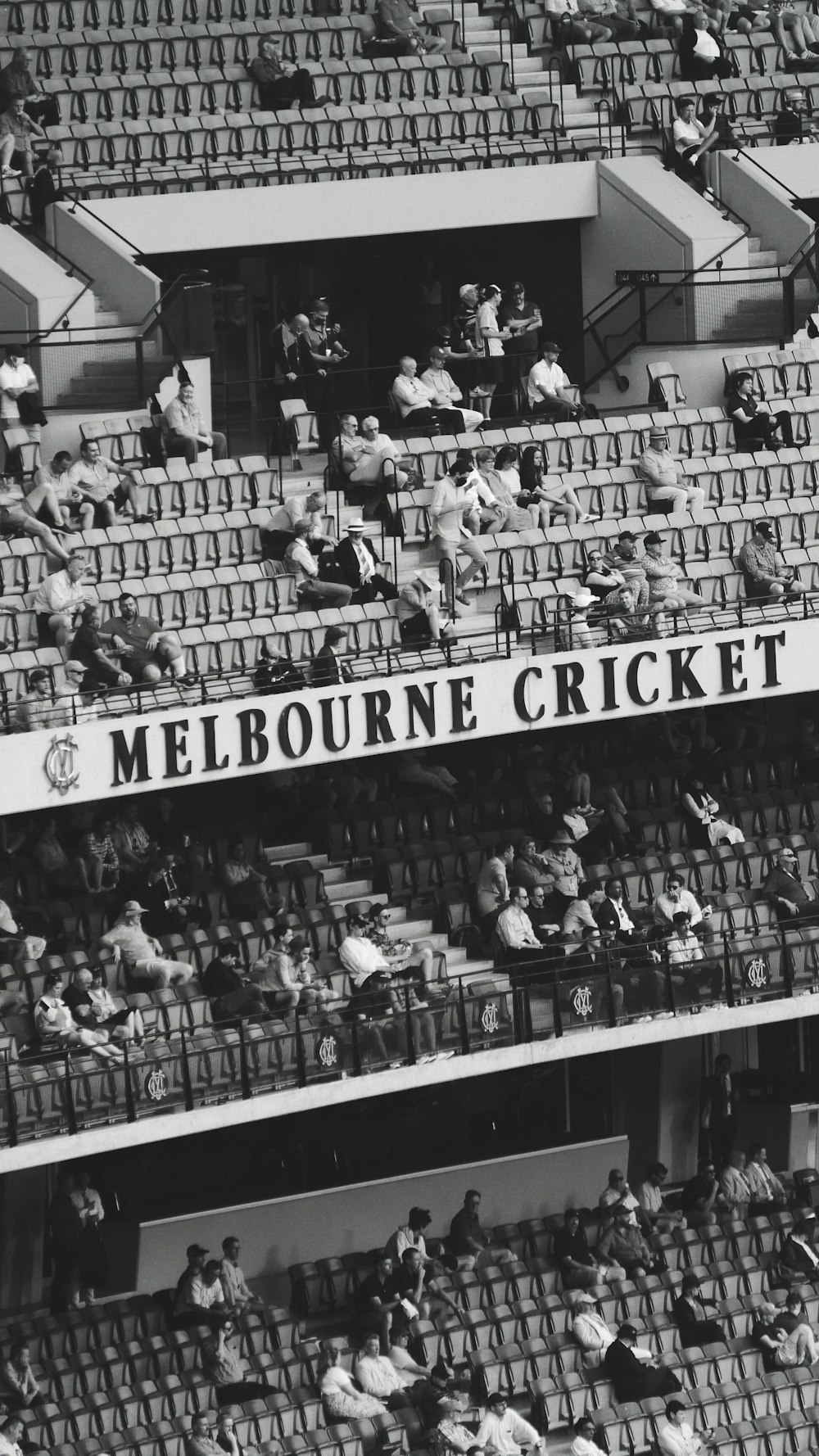 grayscale photo of people in stadium