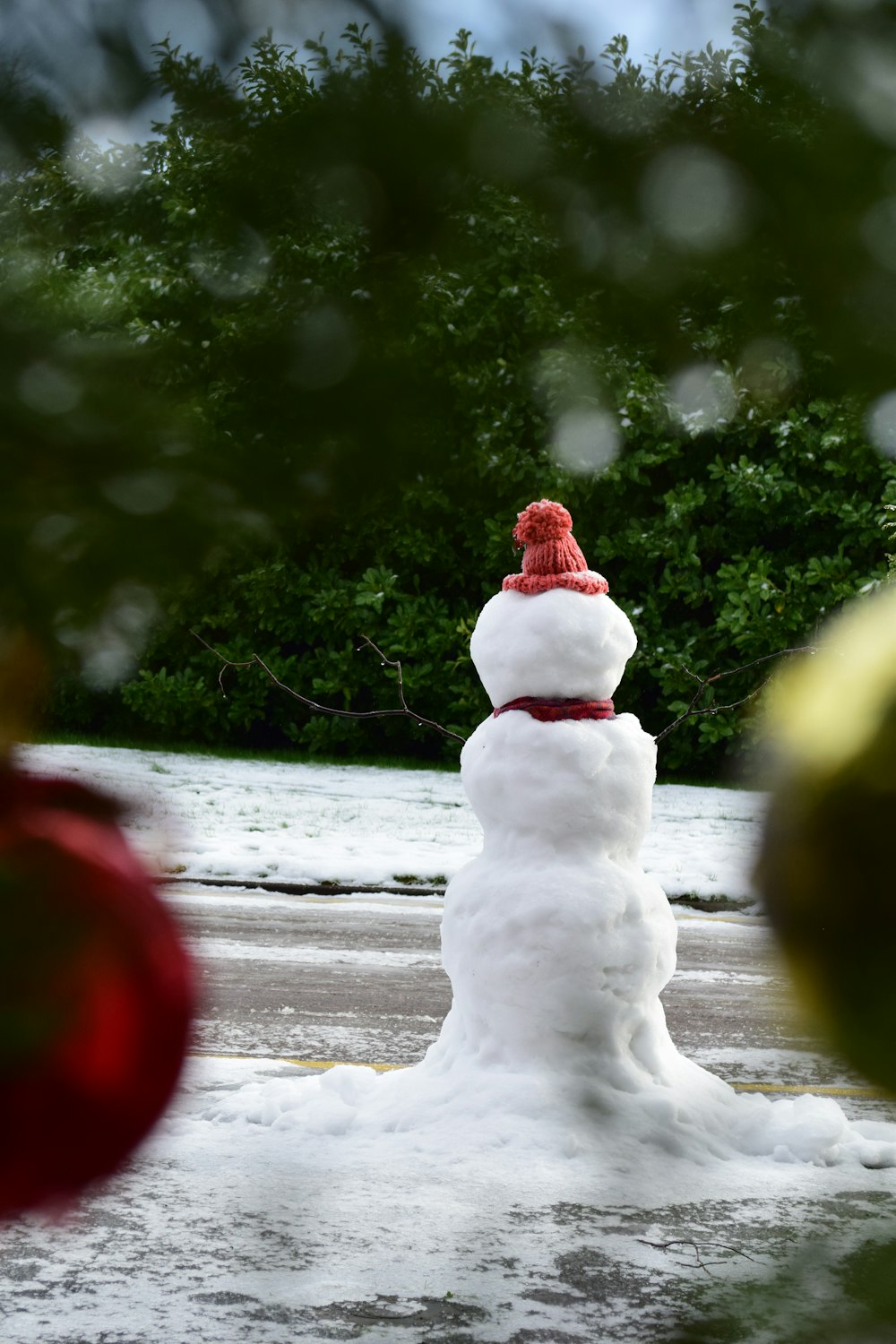snowman figurine on snow covered ground