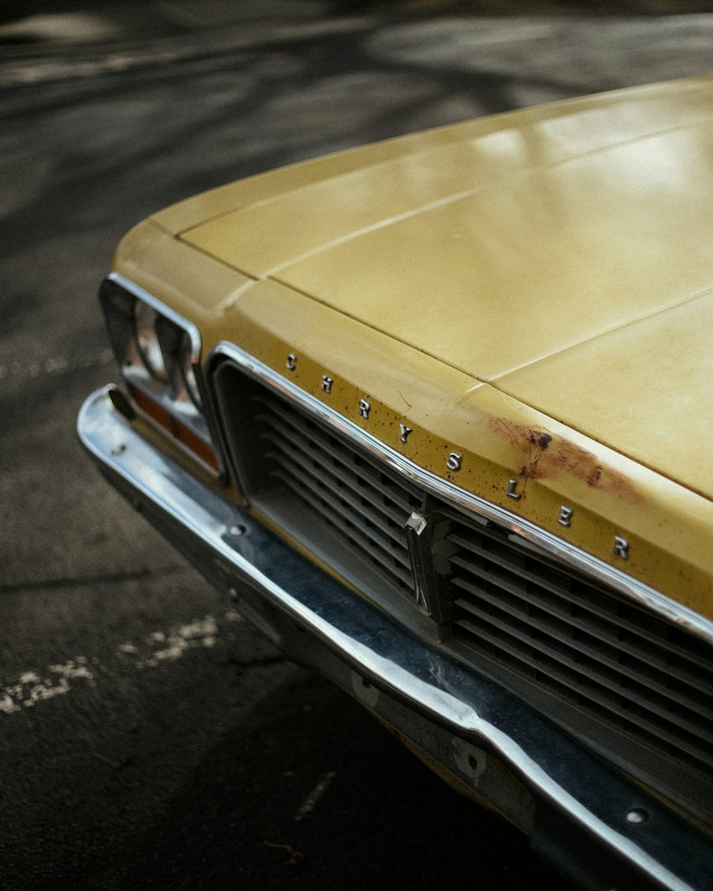 yellow car on gray asphalt road during daytime