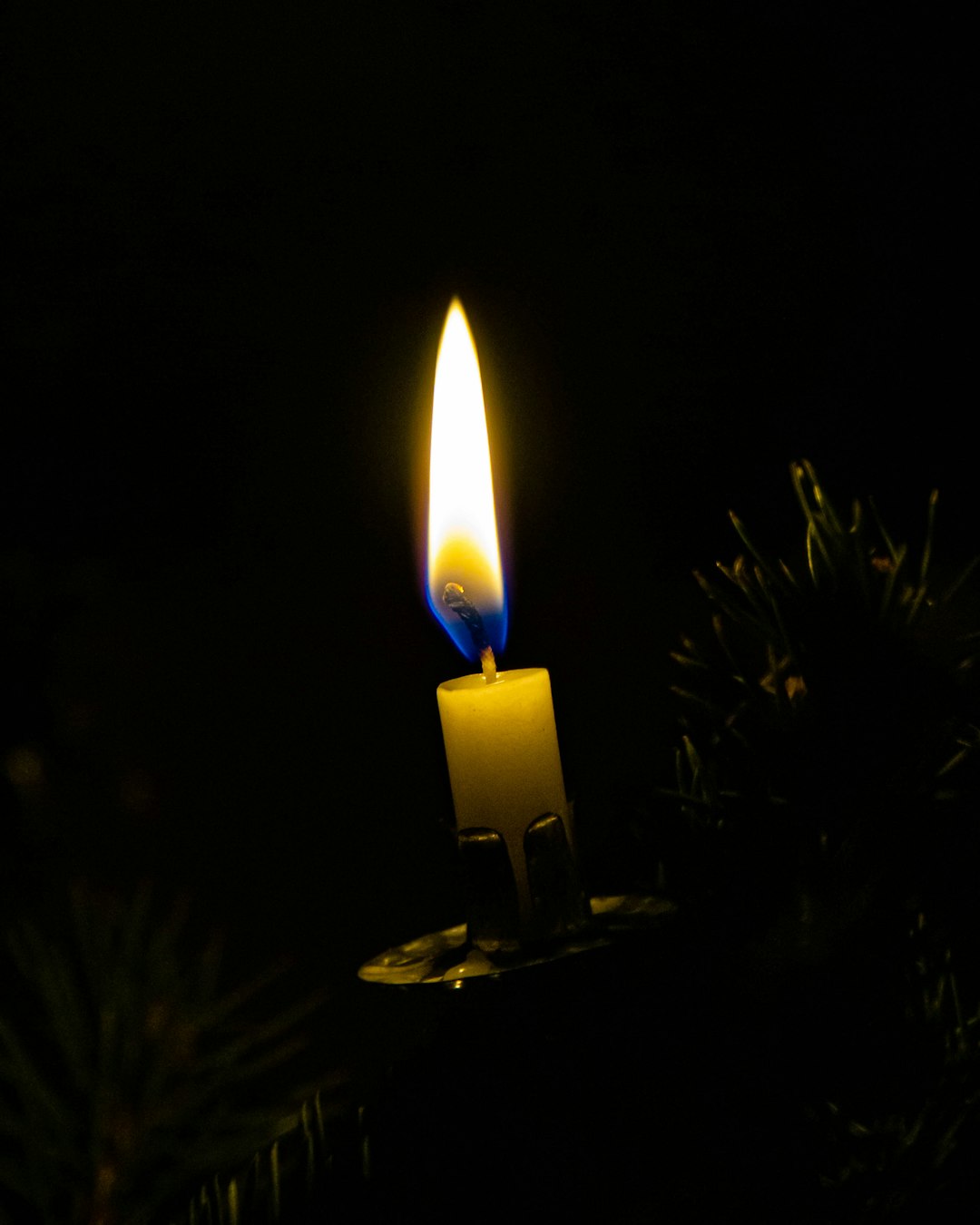 lighted candle in dark room