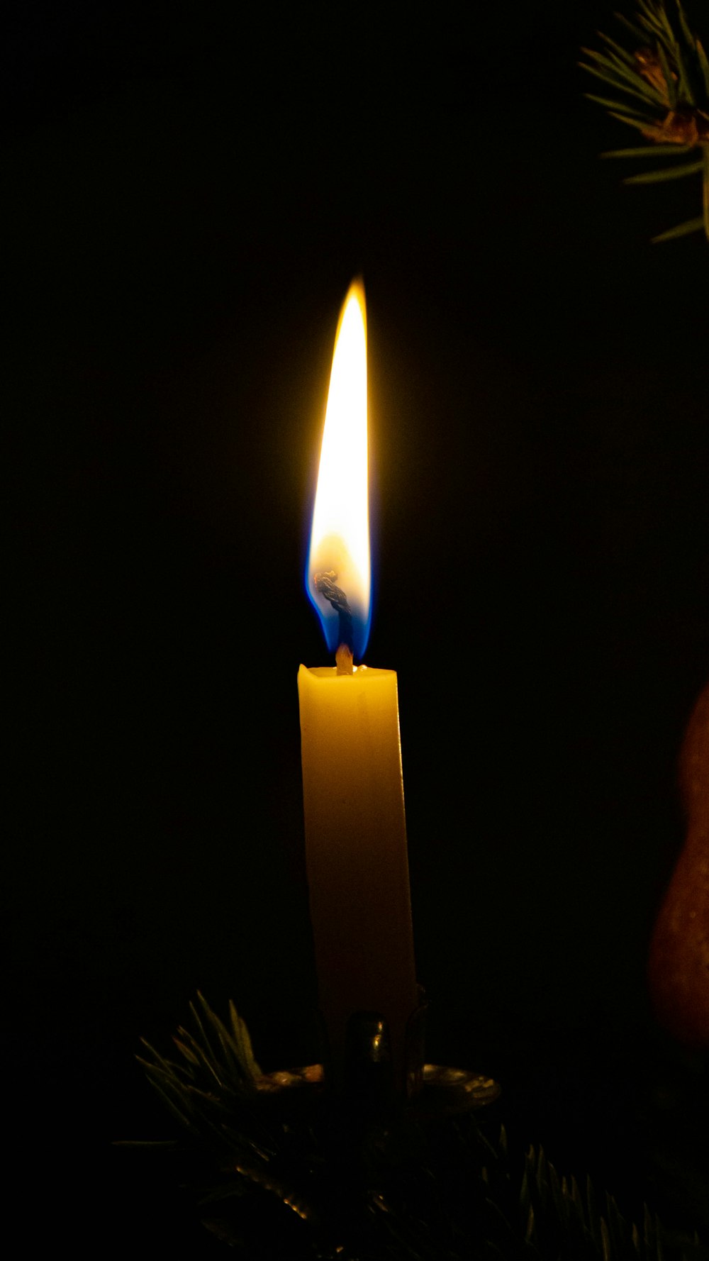 white candle in dark room