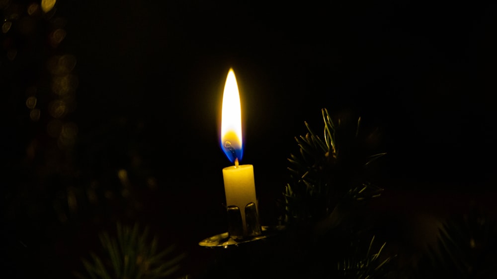 lighted candle in dark room