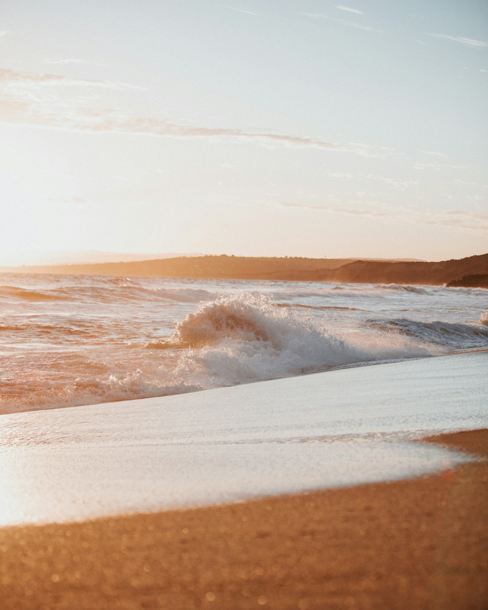 ocean waves crashing on shore during daytime