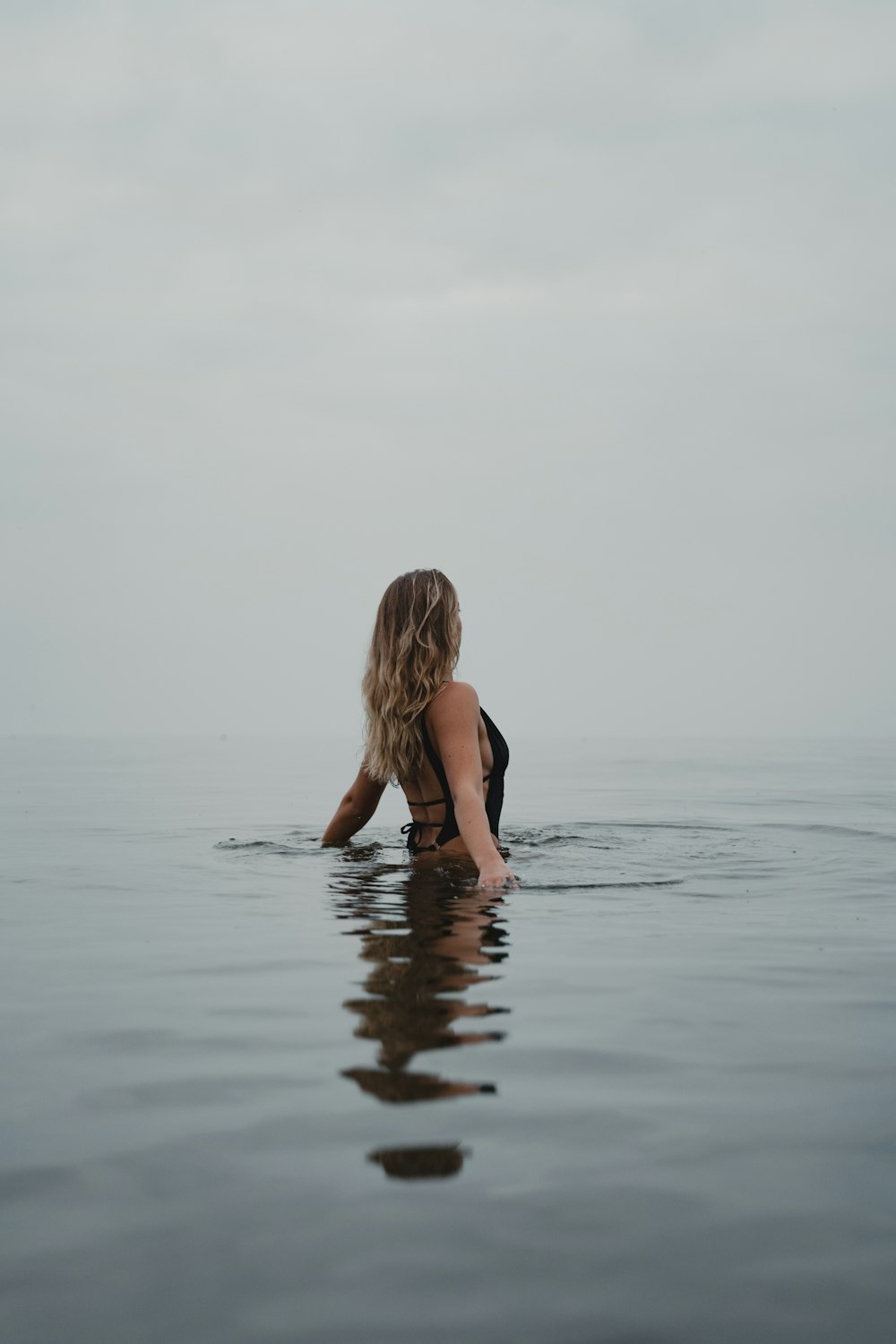 woman in black bikini on water