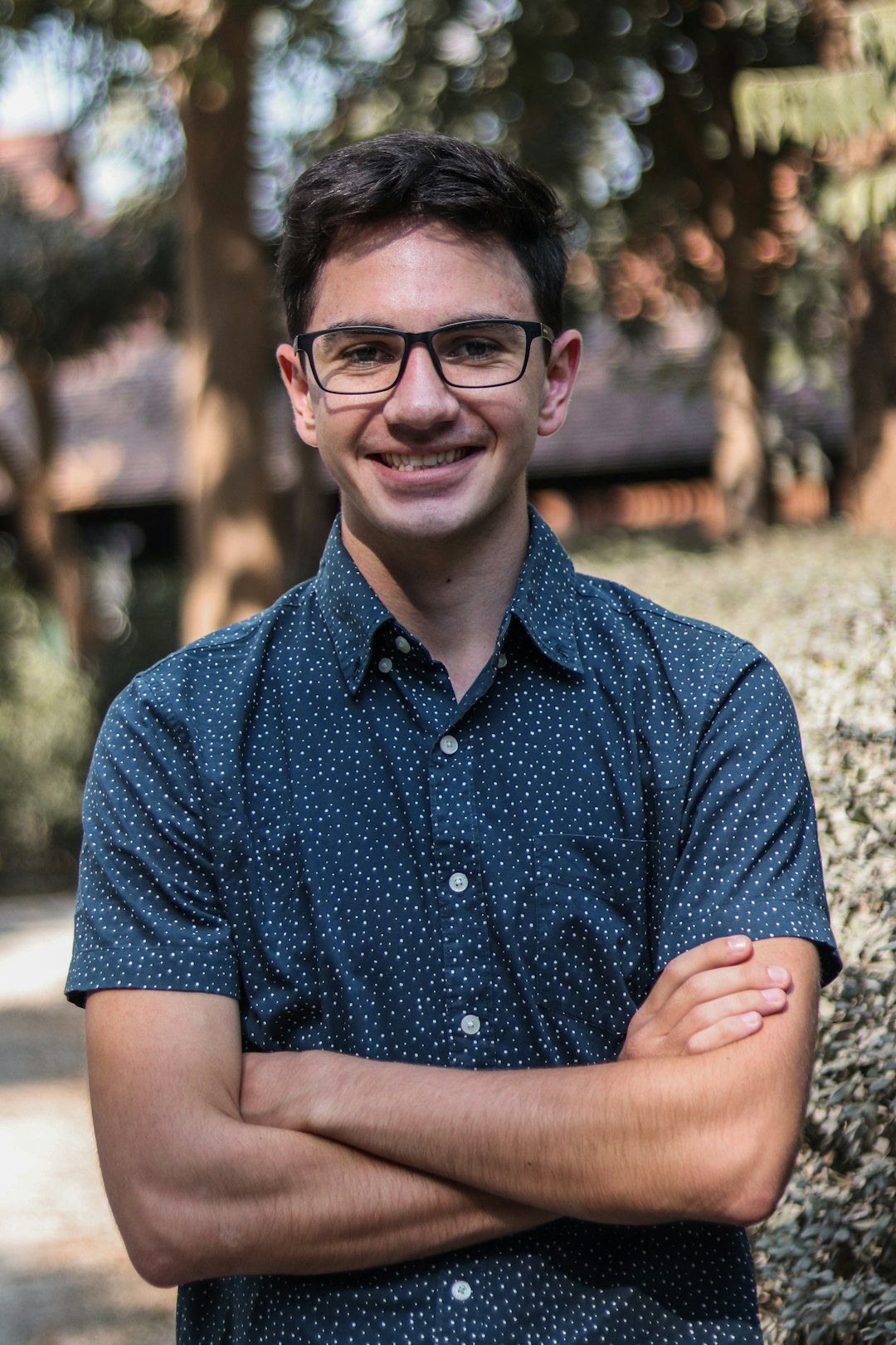 man in blue button up shirt wearing black framed eyeglasses