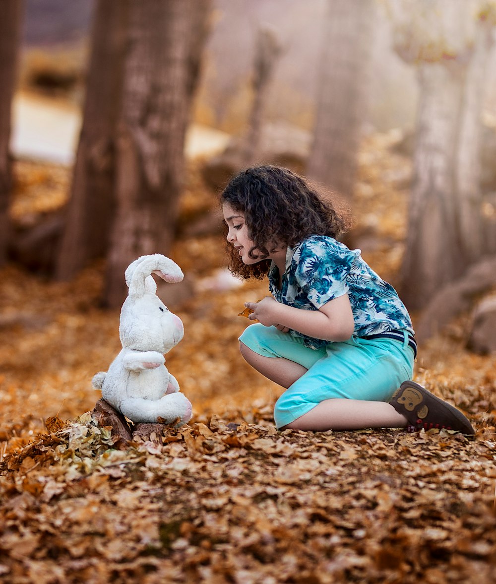 woman in blue dress sitting on ground