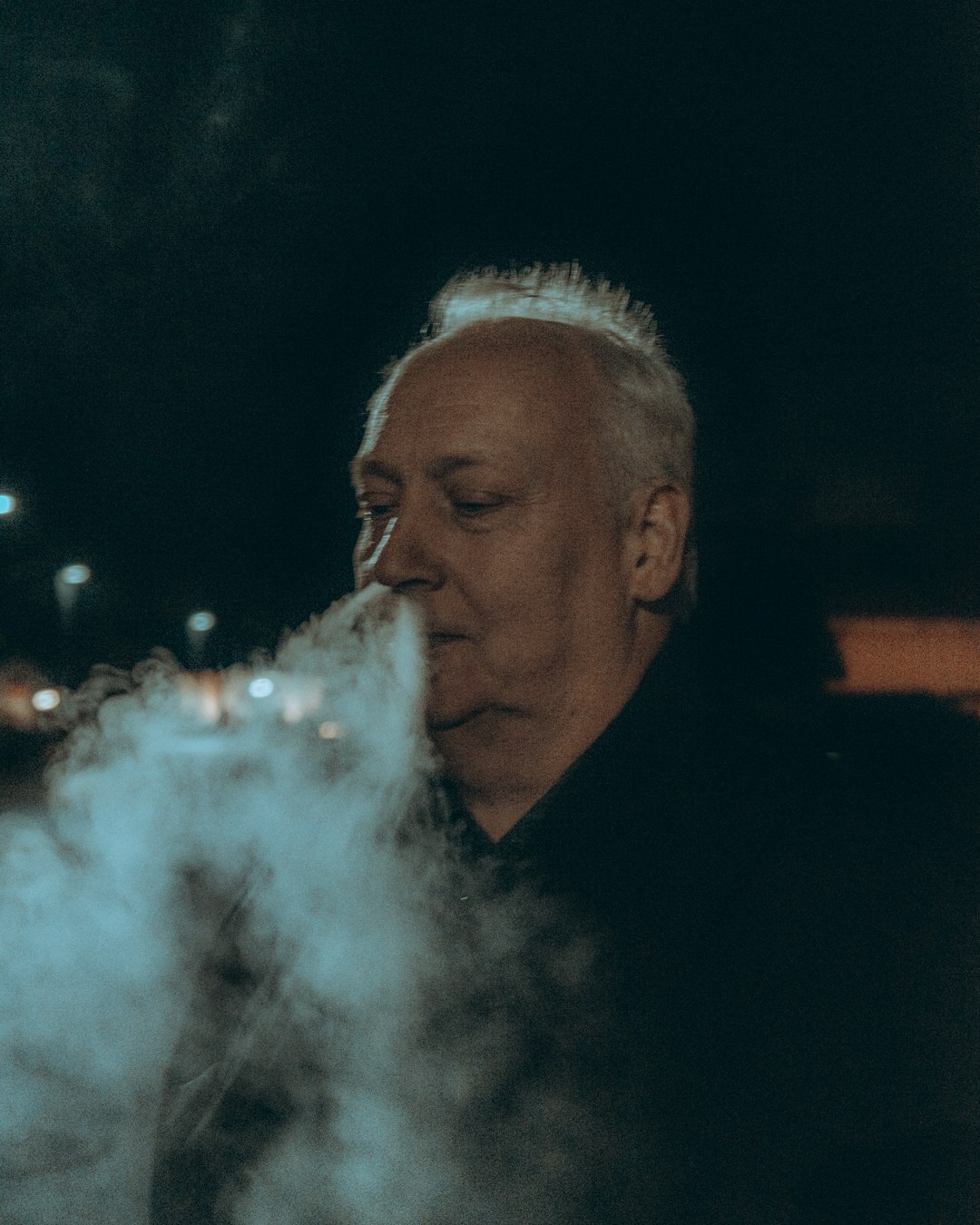 man in black shirt smoking