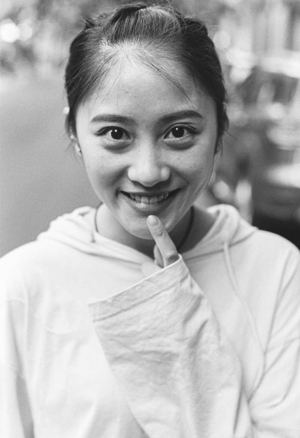 grayscale photo of smiling woman in white shirt