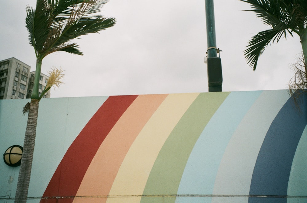 white and red concrete building near palm tree during daytime