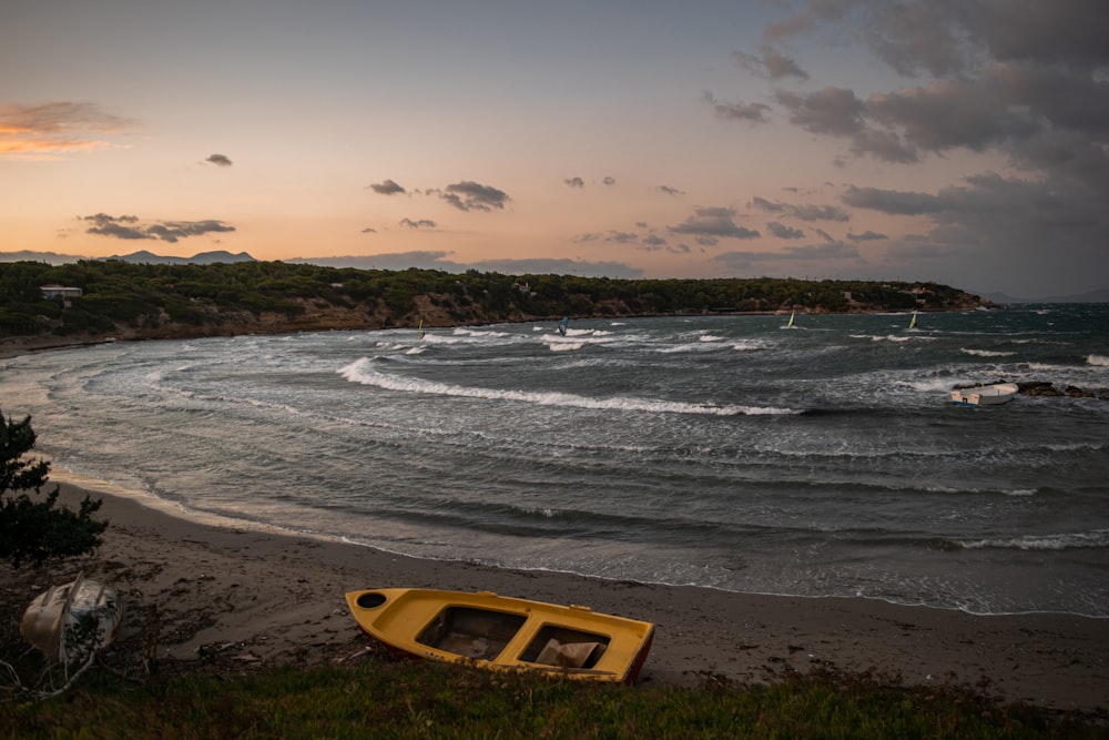 yellow and black boat on seashore during daytime