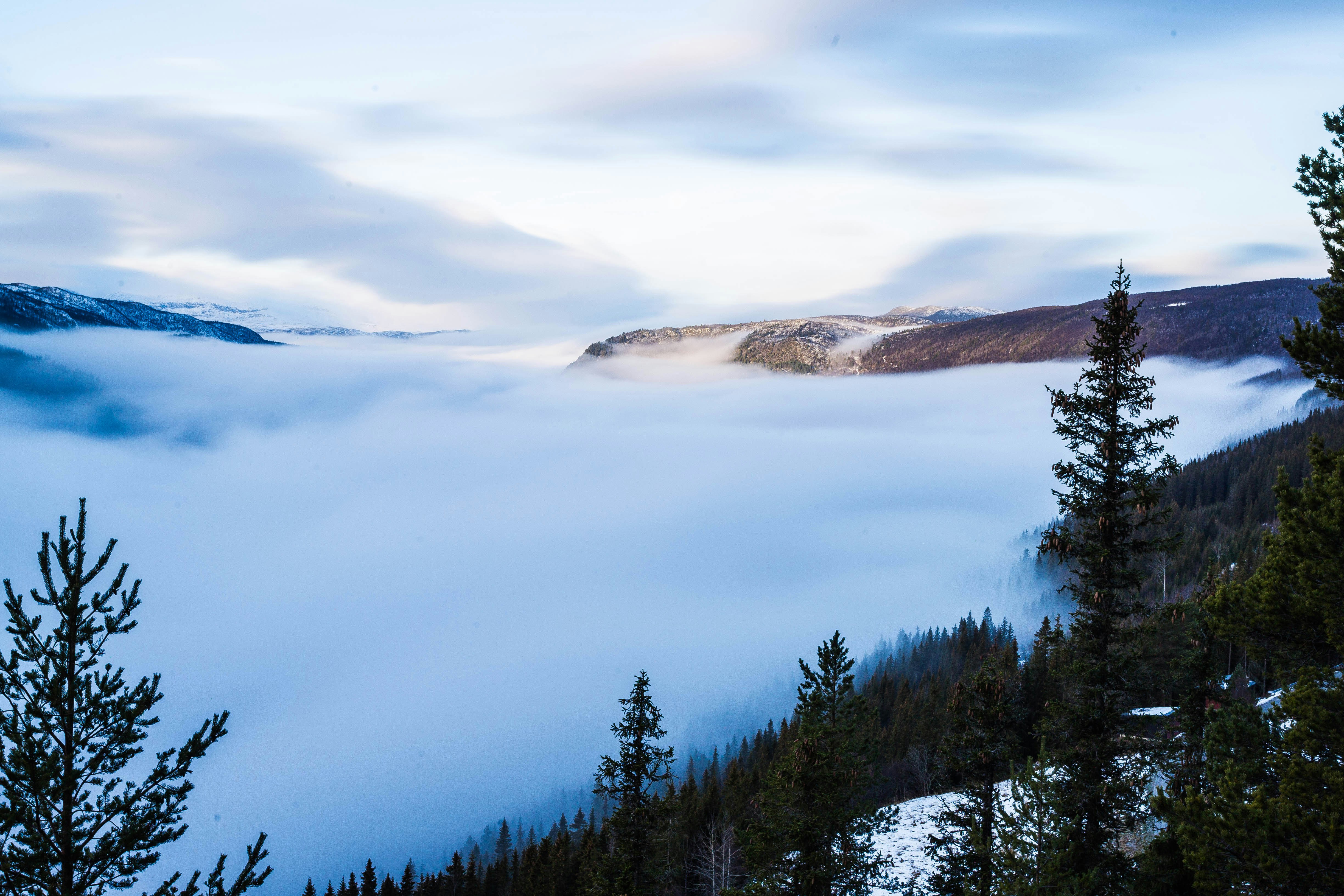 A view of a mountain covered in low lying clouds photo Free Hol Image