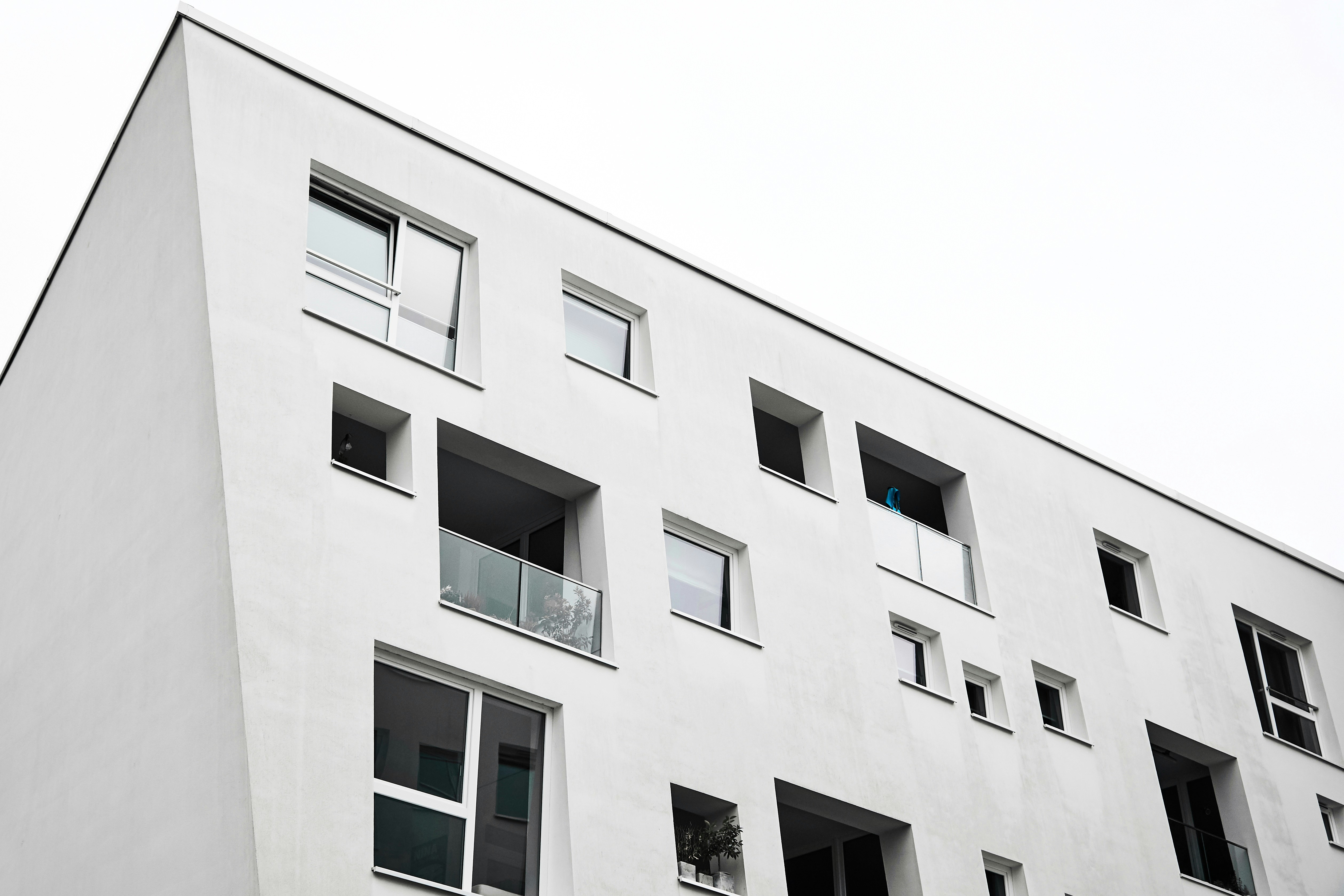 white concrete building with glass windows