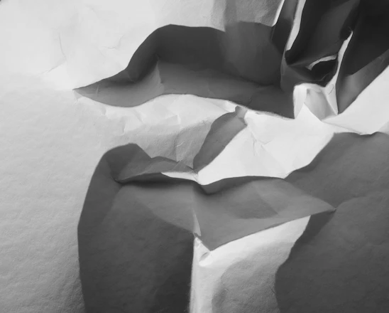 Abstract layered collage of paper textures and soft shadows reflecting structured creativity