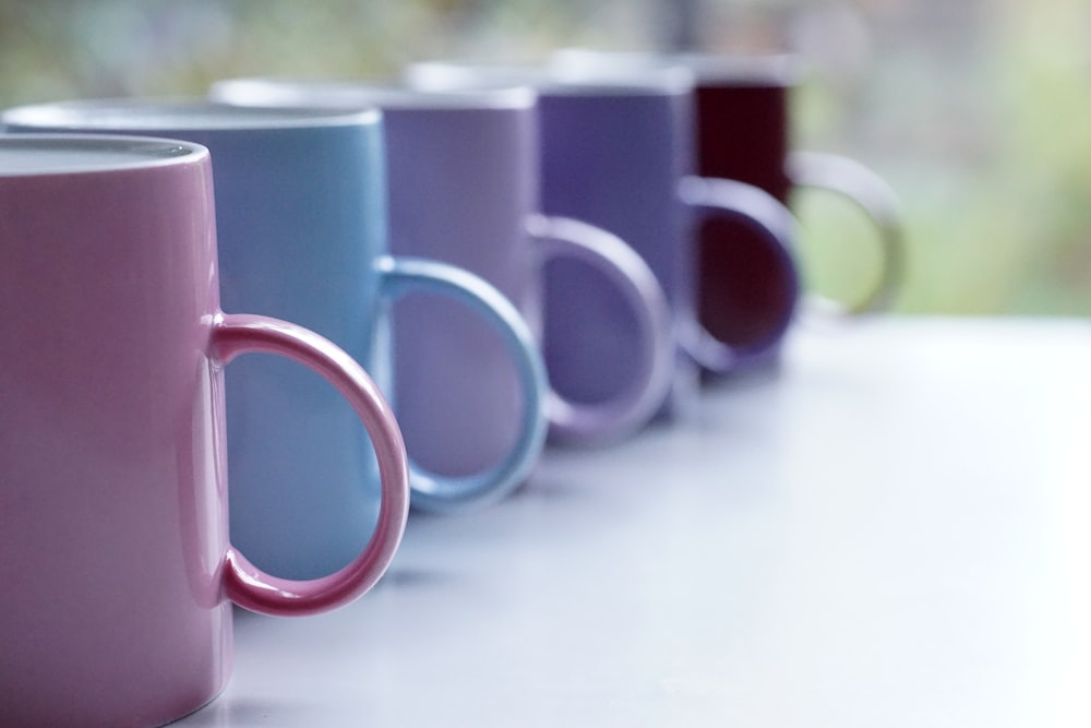 pink ceramic mug on white table