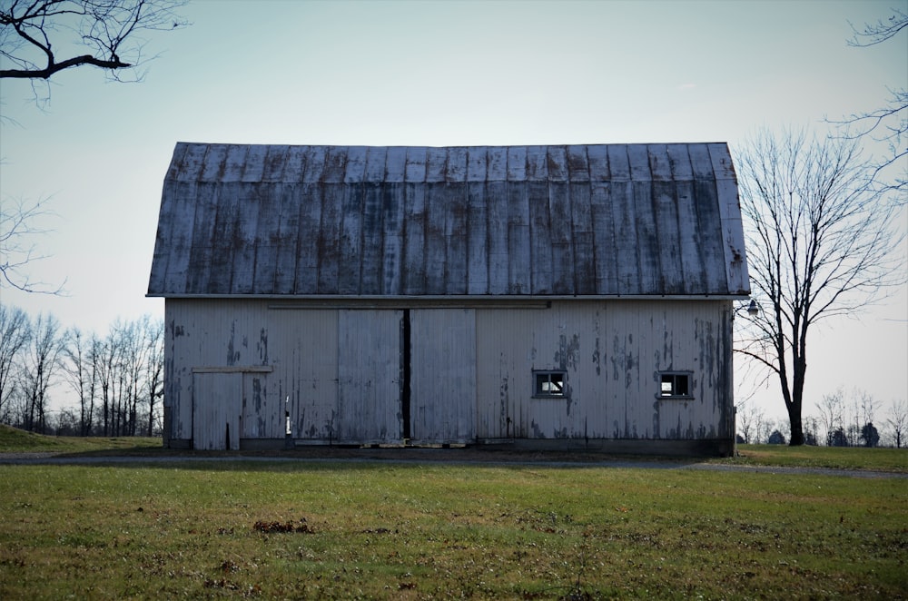 brown wooden barn house on green grass field during daytime