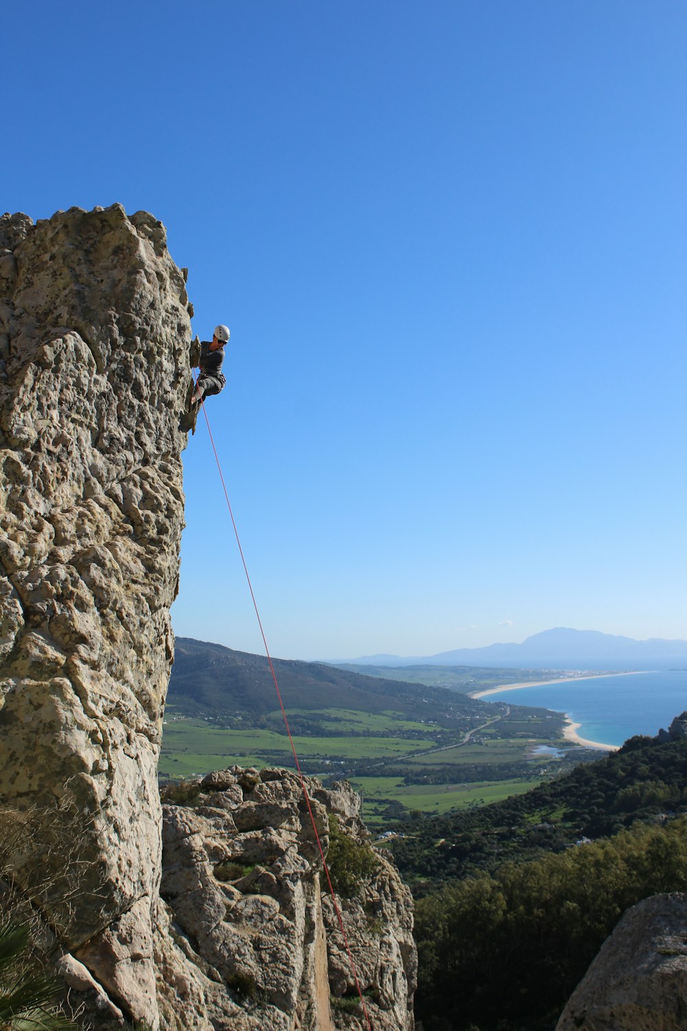 man in black shirt standing on rock formation during daytime