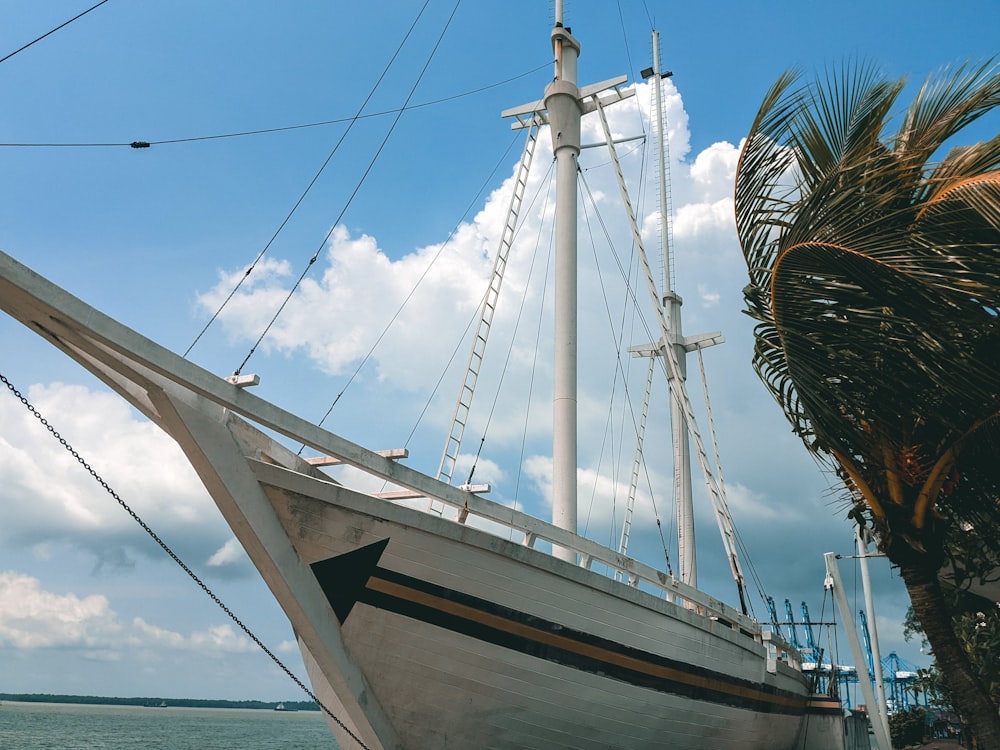 white and brown sail boat on sea during daytime